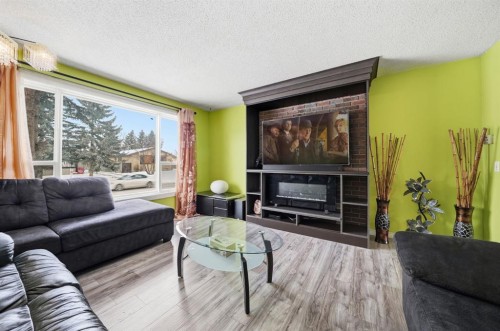 6411 26 Avenue Ne, Calgary, AB - Indoor Photo Showing Living Room With Fireplace