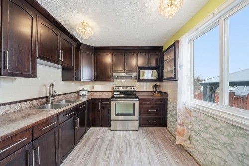 6411 26 Avenue Ne, Calgary, AB - Indoor Photo Showing Kitchen With Stainless Steel Kitchen With Double Sink