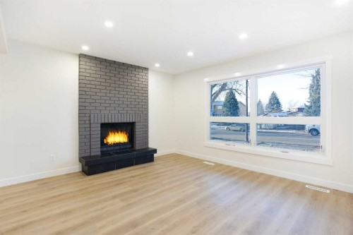 14668 Deer Run Drive Se, Calgary, AB - Indoor Photo Showing Living Room With Fireplace