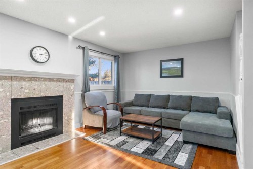 15-200 Shawnessy Drive Sw, Calgary, AB - Indoor Photo Showing Living Room With Fireplace