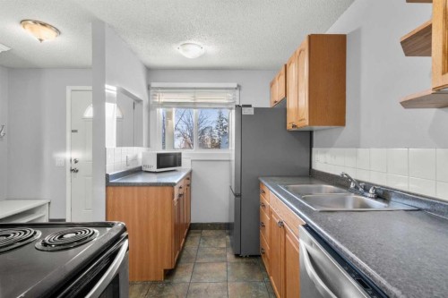 15-200 Shawnessy Drive Sw, Calgary, AB - Indoor Photo Showing Kitchen With Double Sink