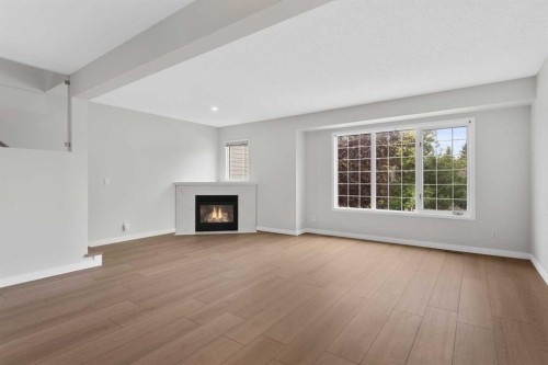 7 Prominence View Sw, Calgary, AB - Indoor Photo Showing Living Room With Fireplace