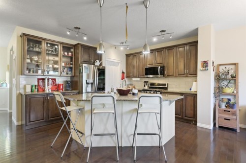 56 Jumping Pound Rise, Cochrane, AB - Indoor Photo Showing Kitchen With Upgraded Kitchen