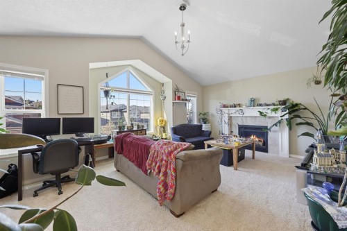 56 Jumping Pound Rise, Cochrane, AB - Indoor Photo Showing Living Room With Fireplace