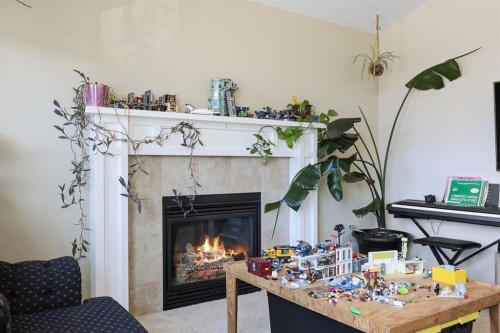 56 Jumping Pound Rise, Cochrane, AB - Indoor With Fireplace