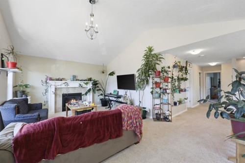 56 Jumping Pound Rise, Cochrane, AB - Indoor With Fireplace