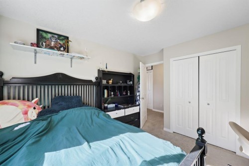 56 Jumping Pound Rise, Cochrane, AB - Indoor Photo Showing Bedroom