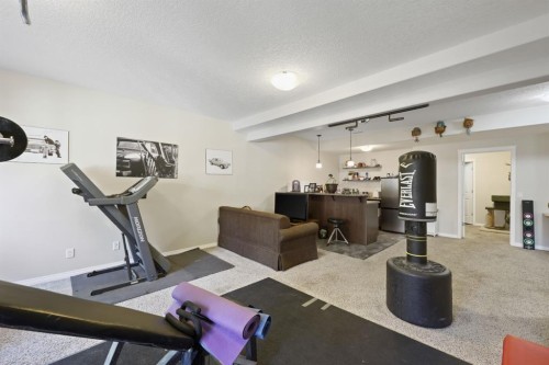 56 Jumping Pound Rise, Cochrane, AB - Indoor Photo Showing Gym Room