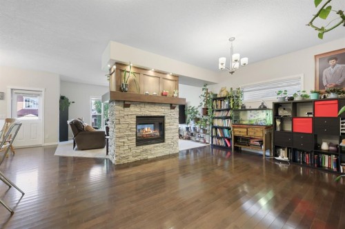 56 Jumping Pound Rise, Cochrane, AB - Indoor Photo Showing Living Room With Fireplace