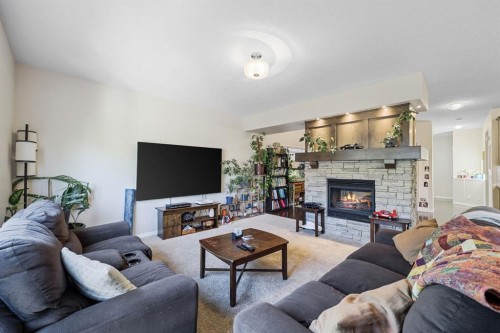 56 Jumping Pound Rise, Cochrane, AB - Indoor Photo Showing Living Room With Fireplace