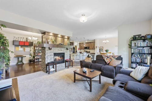 56 Jumping Pound Rise, Cochrane, AB - Indoor Photo Showing Living Room With Fireplace