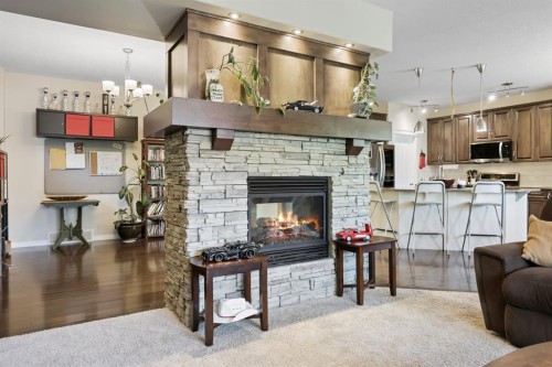 56 Jumping Pound Rise, Cochrane, AB - Indoor Photo Showing Living Room With Fireplace