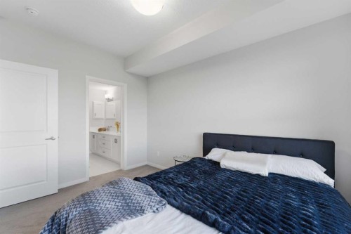 211-4150 Seton Drive Se, Calgary, AB - Indoor Photo Showing Bedroom