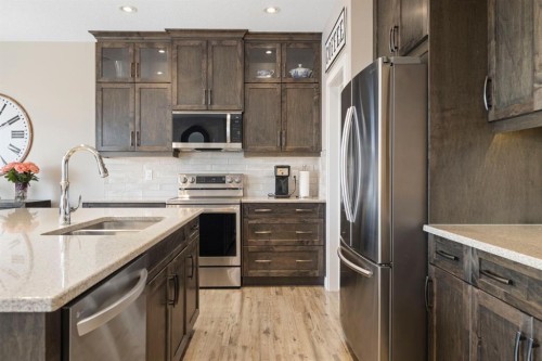 8 Emberside Glen, Cochrane, AB - Indoor Photo Showing Kitchen With Stainless Steel Kitchen With Double Sink With Upgraded Kitchen