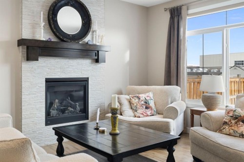8 Emberside Glen, Cochrane, AB - Indoor Photo Showing Living Room With Fireplace