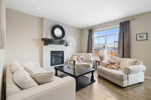 8 Emberside Glen, Cochrane, AB - Indoor Photo Showing Living Room With Fireplace