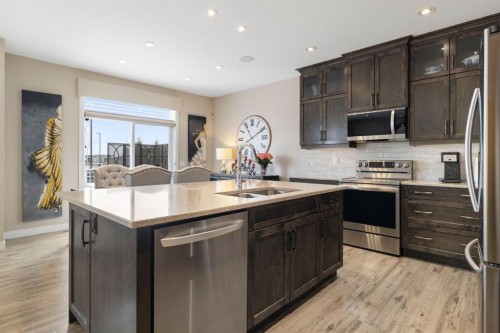 8 Emberside Glen, Cochrane, AB - Indoor Photo Showing Kitchen With Stainless Steel Kitchen With Double Sink With Upgraded Kitchen