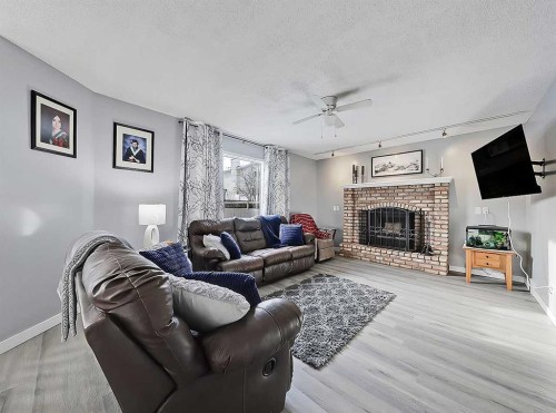 9 Hunters Mews, Okotoks, AB - Indoor Photo Showing Living Room With Fireplace