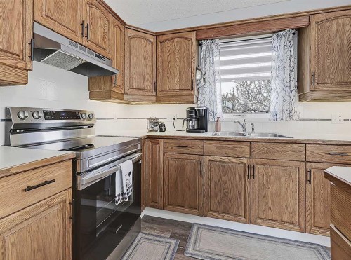 9 Hunters Mews, Okotoks, AB - Indoor Photo Showing Kitchen With Double Sink