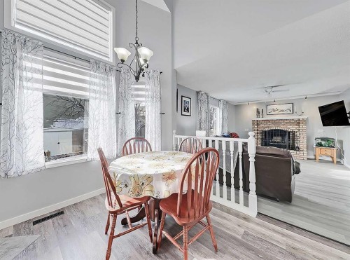 9 Hunters Mews, Okotoks, AB - Indoor Photo Showing Dining Room With Fireplace
