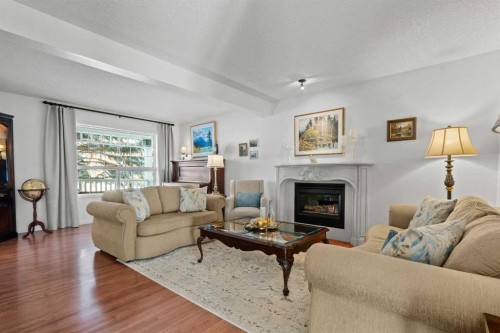 63 Springbank Crescent Sw, Calgary, AB - Indoor Photo Showing Living Room With Fireplace