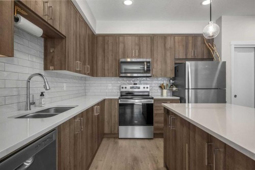 210-660 Shawnee Square Sw, Calgary, AB - Indoor Photo Showing Kitchen With Double Sink With Upgraded Kitchen