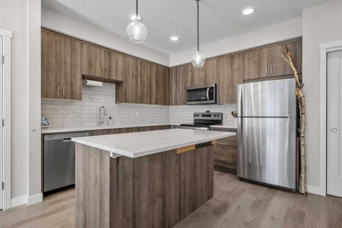 210-660 Shawnee Square Sw, Calgary, AB - Indoor Photo Showing Kitchen With Upgraded Kitchen