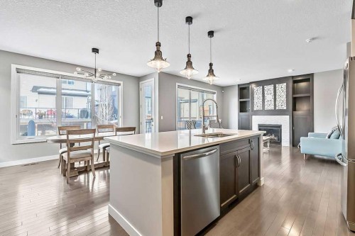 94 Cimarron Springs Circle, Okotoks, AB - Indoor Photo Showing Kitchen With Fireplace With Upgraded Kitchen