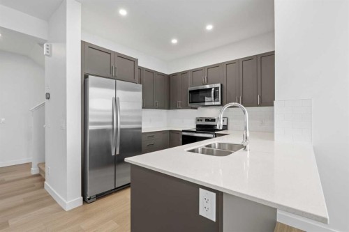 229-65 Belvedere Point Se, Calgary, AB - Indoor Photo Showing Kitchen With Stainless Steel Kitchen With Double Sink With Upgraded Kitchen