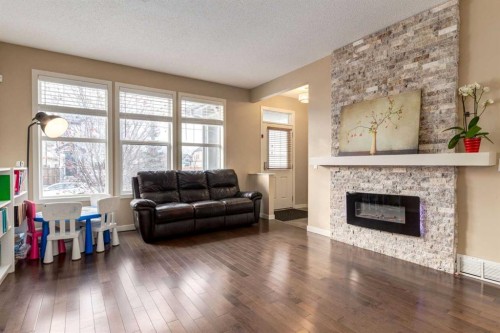 152 New Brighton Grove Se, Calgary, AB - Indoor Photo Showing Living Room With Fireplace