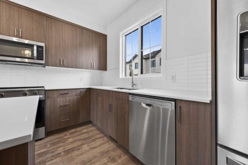 56 Creekside Drive Sw, Calgary, AB - Indoor Photo Showing Kitchen With Double Sink