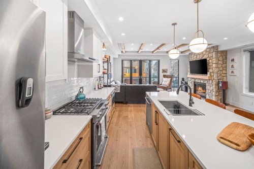 4-810 3Rd Street, Canmore, AB - Indoor Photo Showing Kitchen With Fireplace With Double Sink