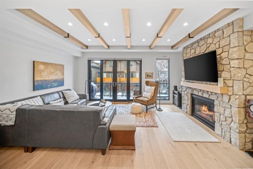 4-810 3Rd Street, Canmore, AB - Indoor Photo Showing Living Room With Fireplace