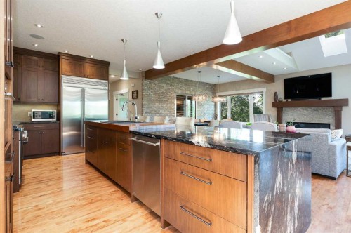 664 29 Avenue Nw, Calgary, AB - Indoor Photo Showing Kitchen With Fireplace With Stainless Steel Kitchen With Upgraded Kitchen