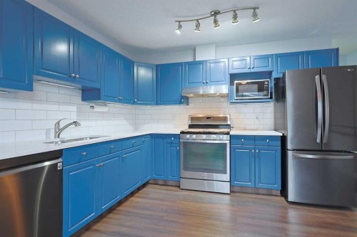 19 Sunridge Crescent Nw, Airdrie, AB - Indoor Photo Showing Kitchen With Stainless Steel Kitchen With Double Sink