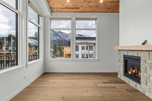 407-1505 Spring Creek Gate, Canmore, AB - Indoor With Fireplace