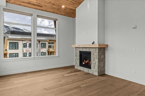 407-1505 Spring Creek Gate, Canmore, AB - Indoor Photo Showing Living Room With Fireplace