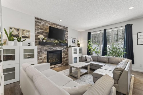 105 Riviera Crescent, Cochrane, AB - Indoor Photo Showing Living Room With Fireplace