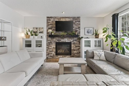 105 Riviera Crescent, Cochrane, AB - Indoor Photo Showing Living Room With Fireplace
