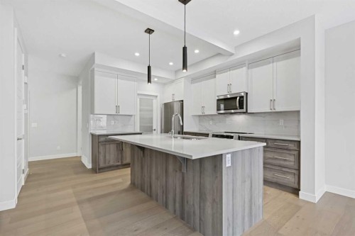 8 Topaz Place, Cochrane, AB - Indoor Photo Showing Kitchen With Upgraded Kitchen
