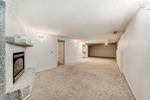 352 Malvern Close Ne, Calgary, AB - Indoor Photo Showing Other Room With Fireplace