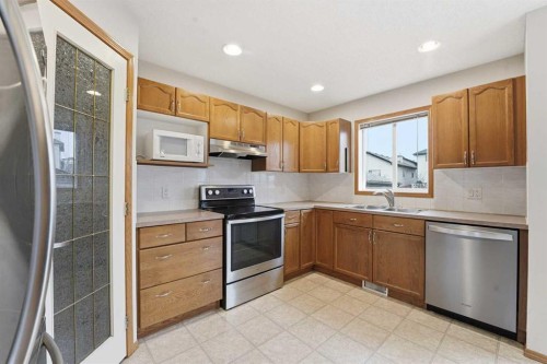 905 Arbour Lake Road Nw, Calgary, AB - Indoor Photo Showing Kitchen With Stainless Steel Kitchen With Double Sink