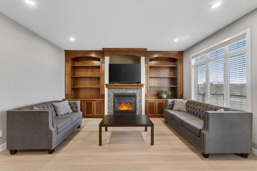 91 Kinlea Link Nw, Calgary, AB - Indoor Photo Showing Living Room With Fireplace