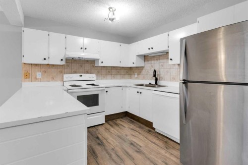 1418 Ranchlands Road Nw, Calgary, AB - Indoor Photo Showing Kitchen With Double Sink