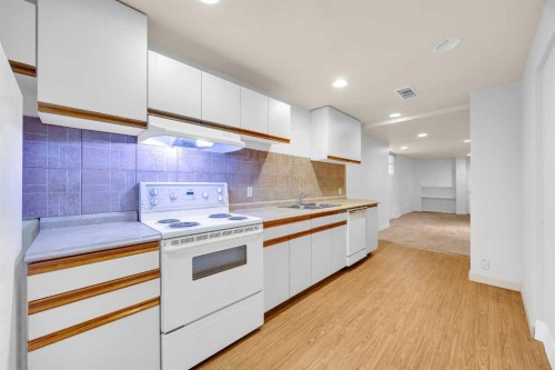 49 Beacham Way Nw, Calgary, AB - Indoor Photo Showing Kitchen With Double Sink