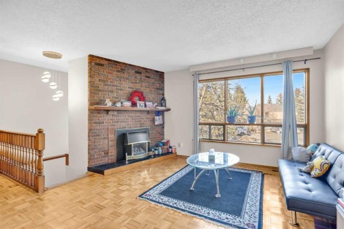 49 Beacham Way Nw, Calgary, AB - Indoor Photo Showing Living Room With Fireplace