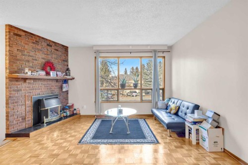 49 Beacham Way Nw, Calgary, AB - Indoor Photo Showing Living Room With Fireplace