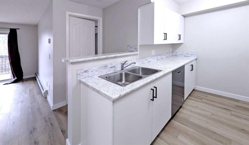 1204-2371 Eversyde Avenue Sw, Calgary, AB - Indoor Photo Showing Kitchen With Double Sink