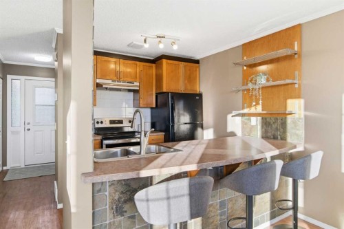 6-99 Grier Place Ne, Calgary, AB - Indoor Photo Showing Kitchen With Double Sink