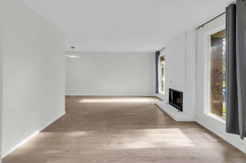 10 Radcliffe Crescent Se, Calgary, AB - Indoor Photo Showing Other Room With Fireplace